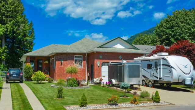 home with an RV parked out front